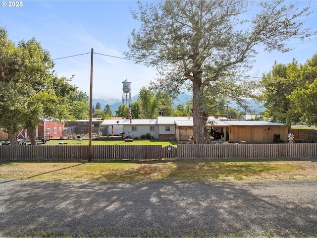 view of front of property with a fenced front yard and a metal roof
