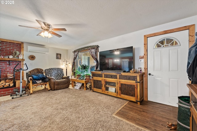 living room featuring an AC wall unit, a ceiling fan, and a textured ceiling