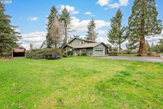 view of front of home featuring aphalt driveway, a carport, a garage, and a front yard