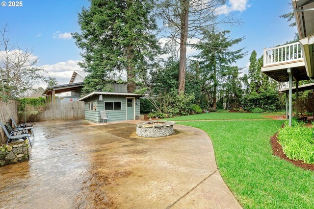 view of yard featuring a fire pit and an outdoor structure