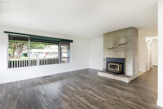 unfurnished living room with visible vents, baseboards, and dark wood-style flooring