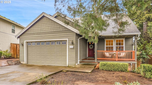 view of front of property featuring concrete driveway, a garage, covered porch, and a shingled roof