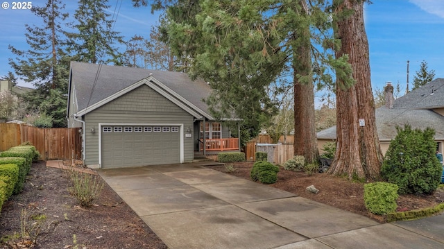 exterior space featuring an attached garage, fence, and driveway