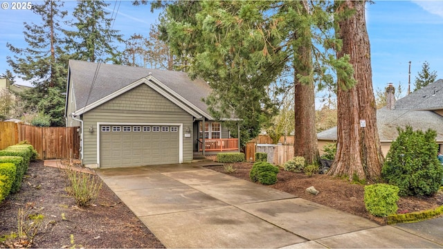 view of front of house with fence, a garage, and driveway