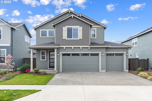 view of front of property with a front lawn and a garage