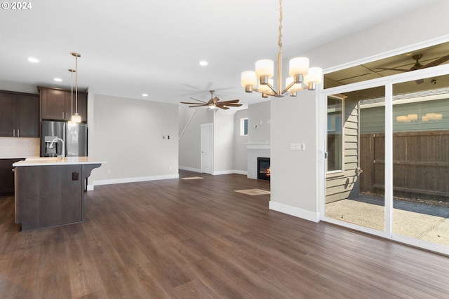 interior space featuring dark hardwood / wood-style flooring and ceiling fan with notable chandelier