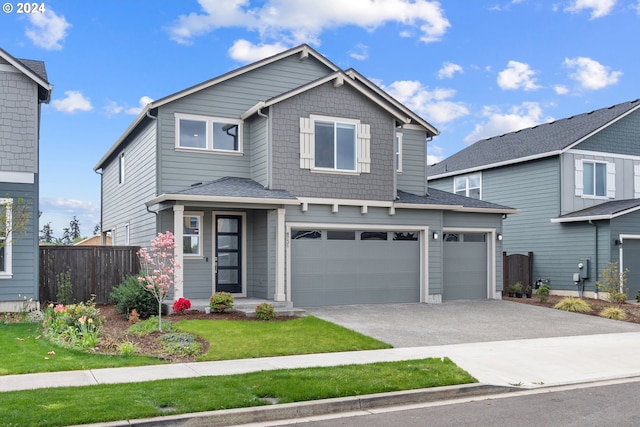 view of front of property featuring a garage and a front yard