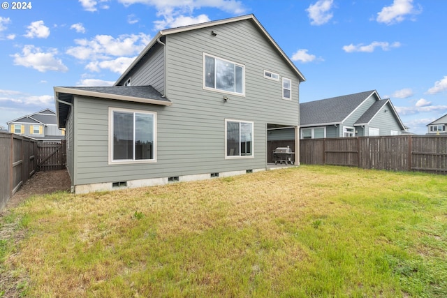 rear view of house with a yard