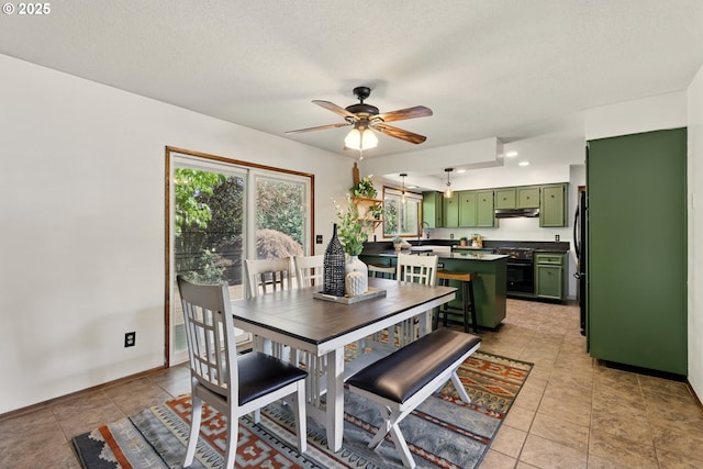 18735 NE Wasco Ct, Portland, OR 97230 - dining space featuring ceiling fan, light tile patterned flooring, baseboards, and a textured ceiling