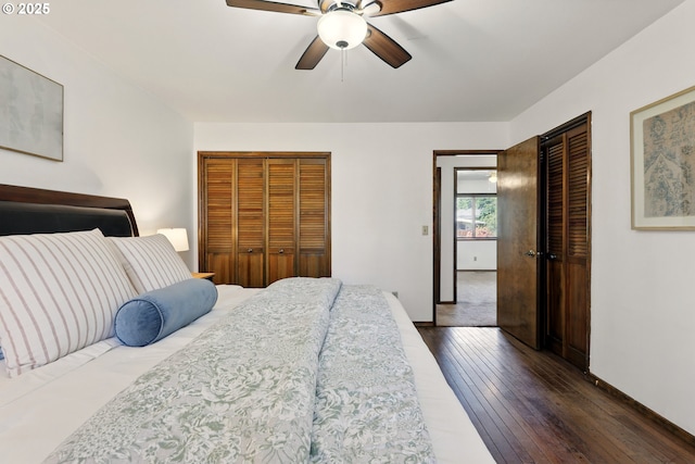 18735 NE Wasco Ct, Portland, OR 97230 - bedroom featuring dark wood-type flooring, baseboards, two closets, and ceiling fan