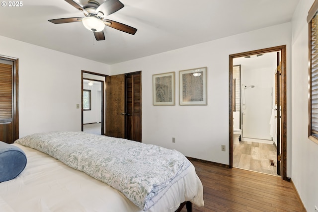 18735 NE Wasco Ct, Portland, OR 97230 - bedroom with dark wood-style floors, baseboards, a closet, ceiling fan, and ensuite bath