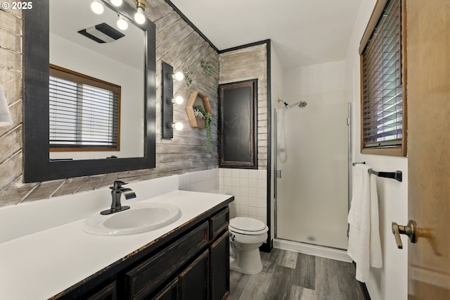 18735 NE Wasco Ct, Portland, OR 97230 - full bath featuring toilet, vanity, a stall shower, wood finished floors, and tile walls