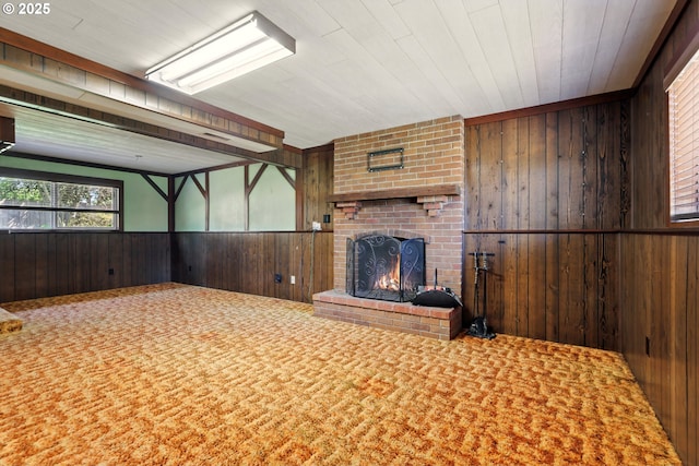 18735 NE Wasco Ct, Portland, OR 97230 - unfurnished living room featuring wooden walls, a fireplace, and carpet flooring