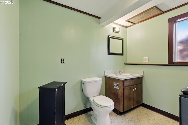 18735 NE Wasco Ct, Portland, OR 97230 - bathroom featuring vanity, toilet, baseboards, and crown molding