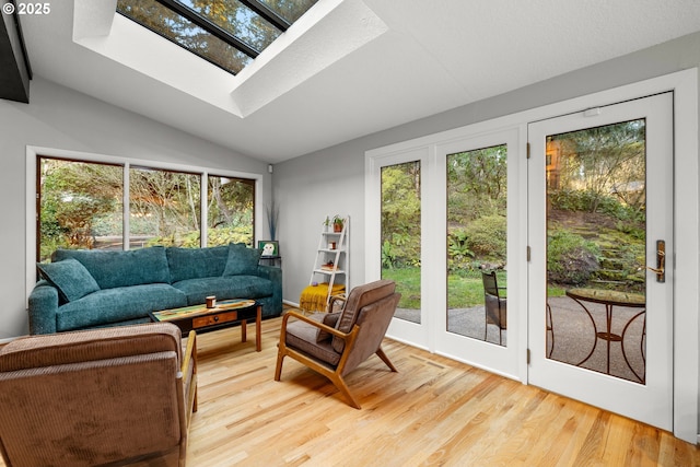 sunroom with lofted ceiling with skylight