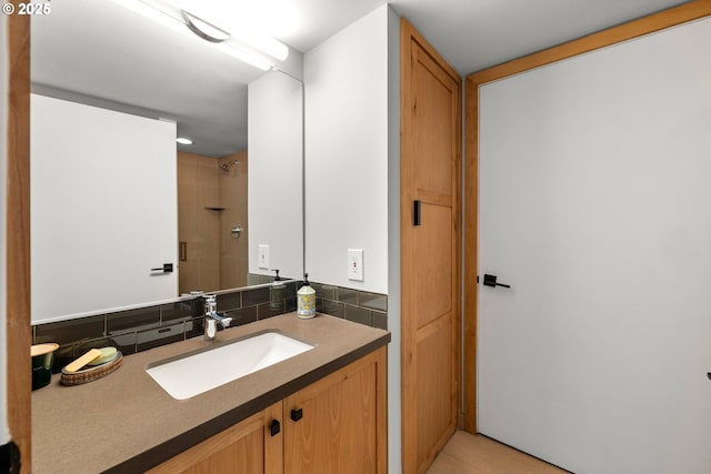 full bathroom featuring walk in shower, backsplash, and vanity