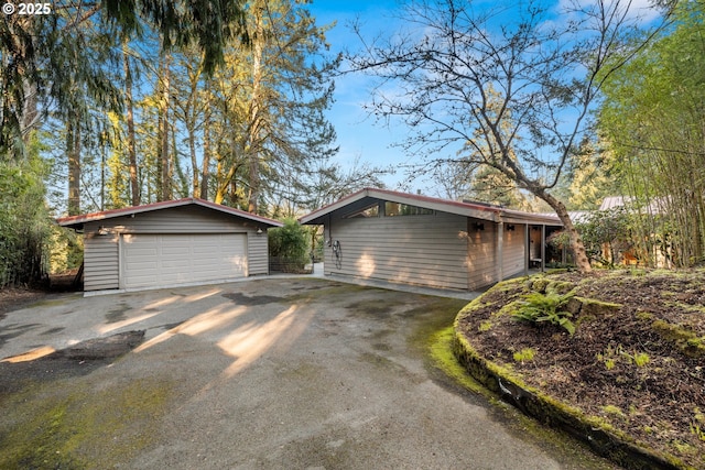 exterior space with an outdoor structure and a detached garage