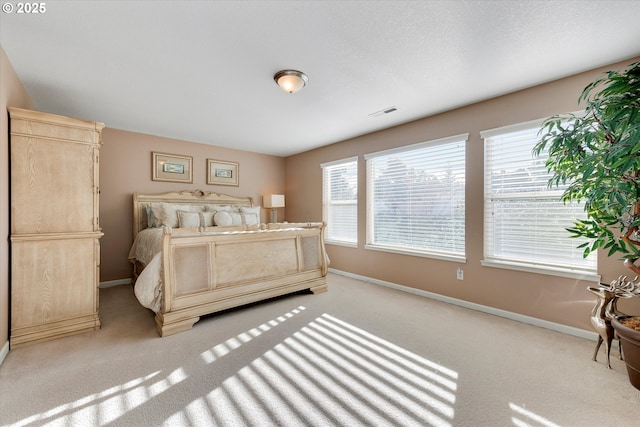 bedroom featuring light carpet