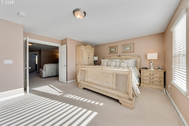 bedroom with light carpet and multiple windows