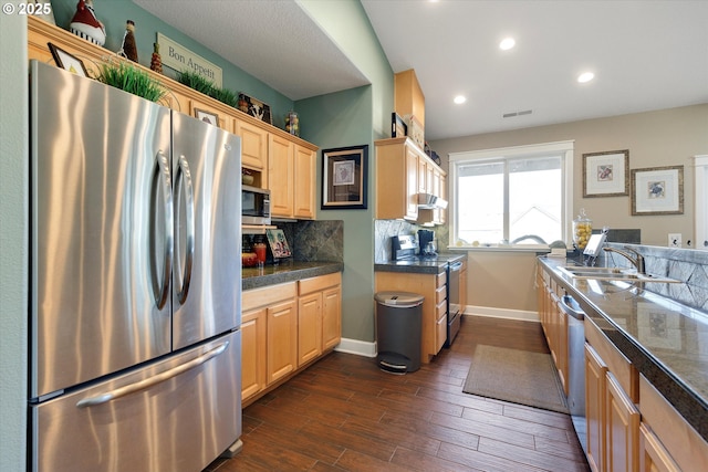 kitchen featuring sink, light brown cabinets, appliances with stainless steel finishes, and tasteful backsplash