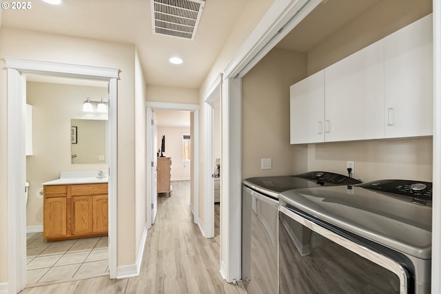 1894 S 8th St, Cottage Grove, OR 97424 - laundry room featuring cabinet space, washer and dryer, light wood-style floors, and recessed lighting
