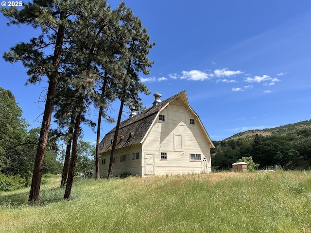 5450 Mill Creek Rd, The Dalles, OR 97058 - view of side of home featuring a barn, an outdoor structure, and a gambrel roof