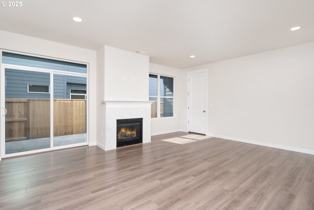 3020 S Kodiak St Unit Lt811, Cornelius, OR 97113 - unfurnished living room featuring wood finished floors, a premium fireplace, and recessed lighting
