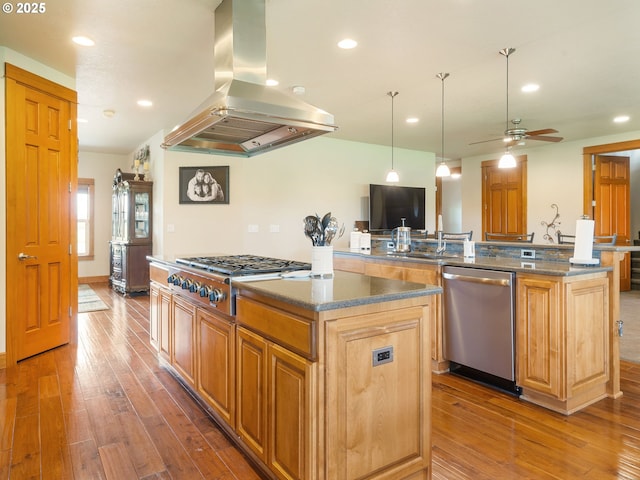 kitchen featuring a kitchen island, island range hood, hardwood / wood-style flooring, a sink, and stainless steel appliances