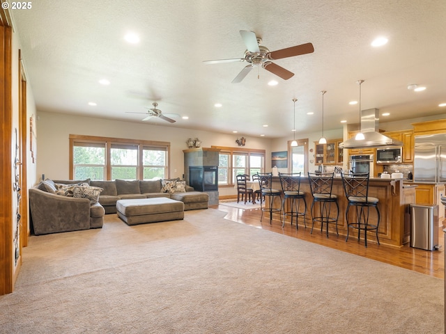 living room with recessed lighting, ceiling fan, and light carpet