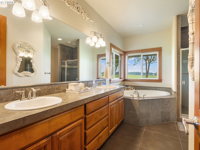 full bathroom featuring a sink, tile patterned floors, a stall shower, and a bath