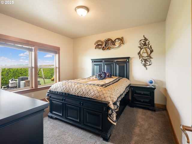 bedroom featuring light colored carpet and baseboards