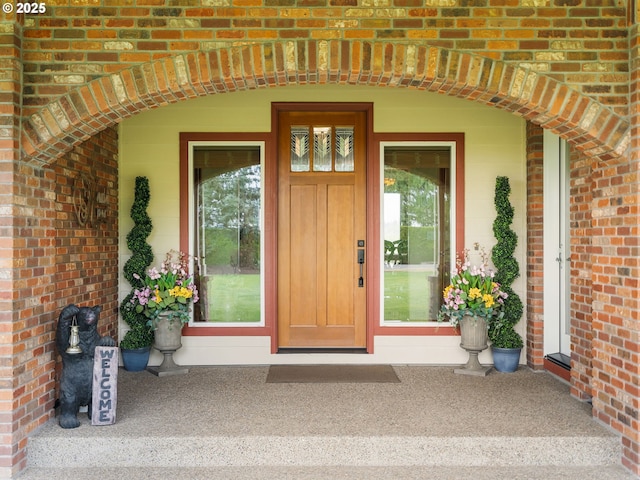 property entrance featuring brick siding