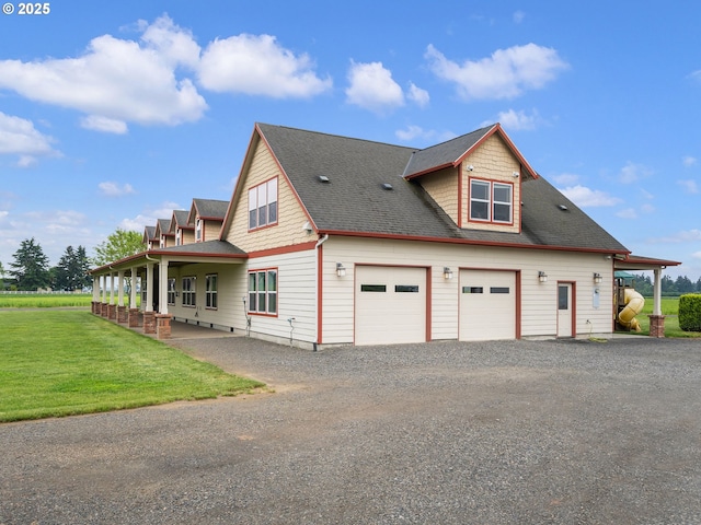 view of side of home featuring a lawn, a shingled roof, and gravel driveway