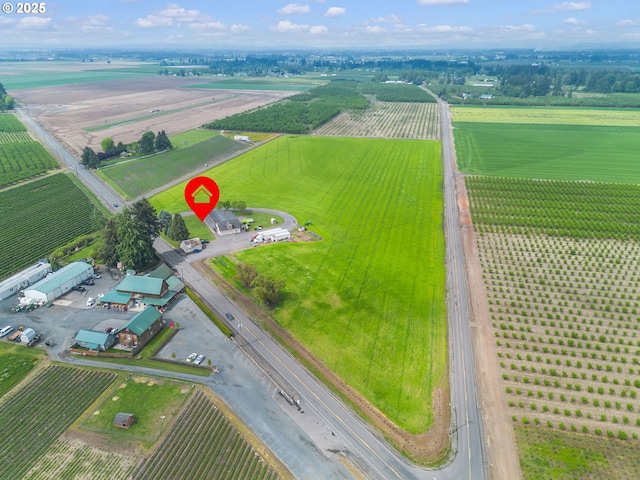 birds eye view of property with a rural view