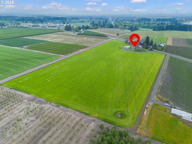 birds eye view of property with a rural view