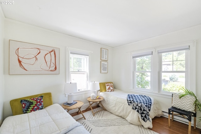 7228 N Villard Ave, Portland, OR 97217 - bedroom featuring multiple windows, wood finished floors, and baseboard heating