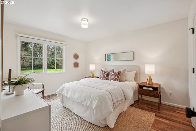 bedroom with baseboards and light wood-style floors