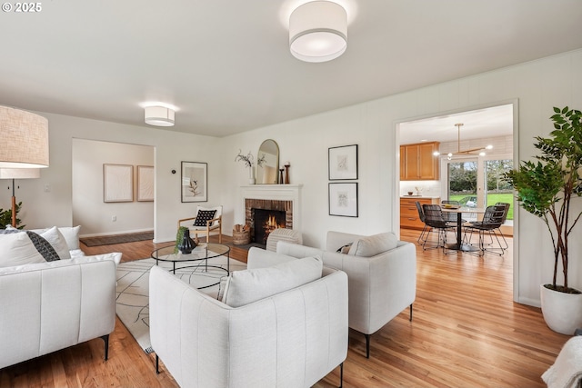 living area featuring a fireplace and light wood-type flooring