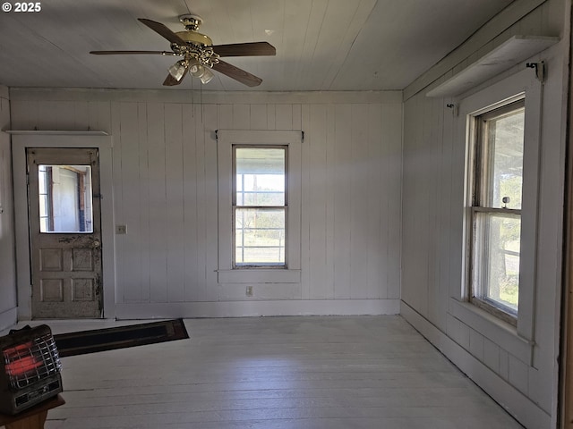 54901 Willow St, Heppner, OR 97836 - unfurnished room featuring light wood-style floors, heating unit, ceiling fan, and wood walls