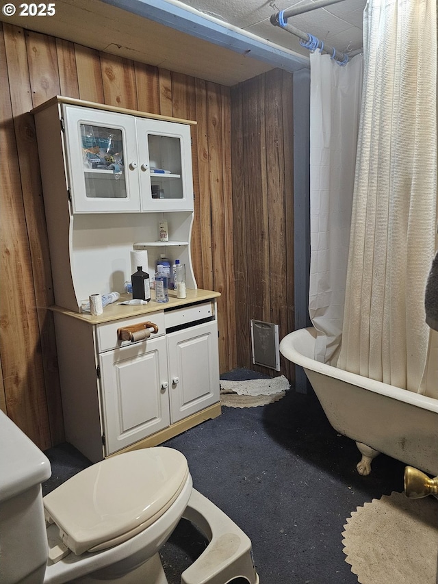 54901 Willow St, Heppner, OR 97836 - bathroom with a freestanding bath, toilet, curtained shower, and wooden walls