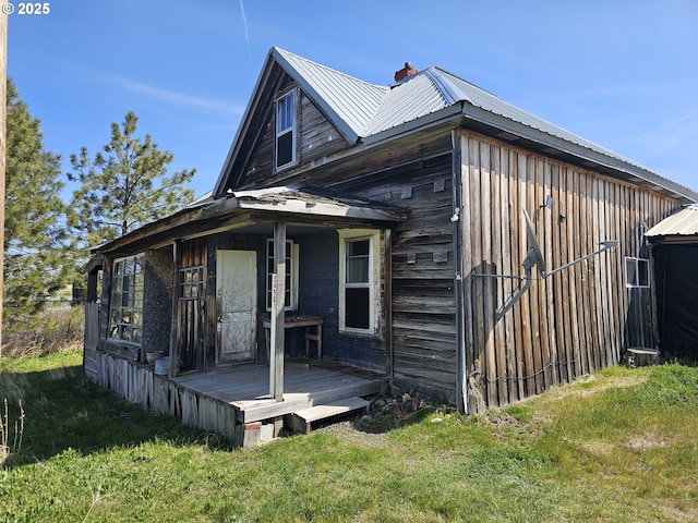 54901 Willow St, Heppner, OR 97836 - rear view of house featuring a yard, metal roof, and a chimney