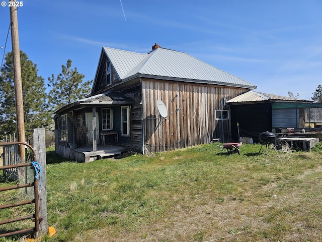 54901 Willow St, Heppner, OR 97836 - view of property exterior featuring a lawn, a wooden deck, and metal roof