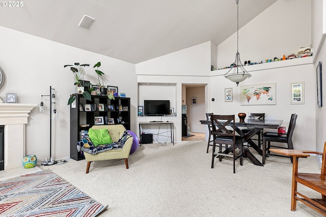 4053 Sabrena Ave, Eugene, OR 97404 - dining room with carpet, high vaulted ceiling, a chandelier, and a fireplace with raised hearth