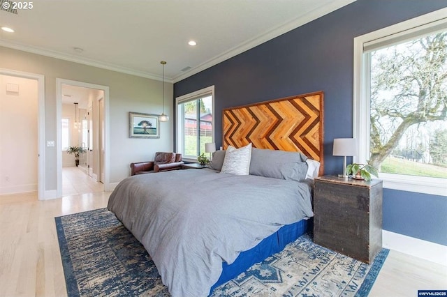 bedroom with recessed lighting, crown molding, baseboards, and wood finished floors