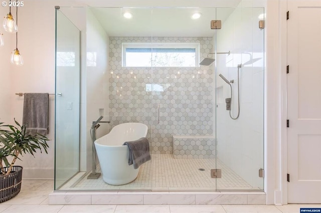 full bath with a shower stall, a freestanding tub, and tile patterned floors