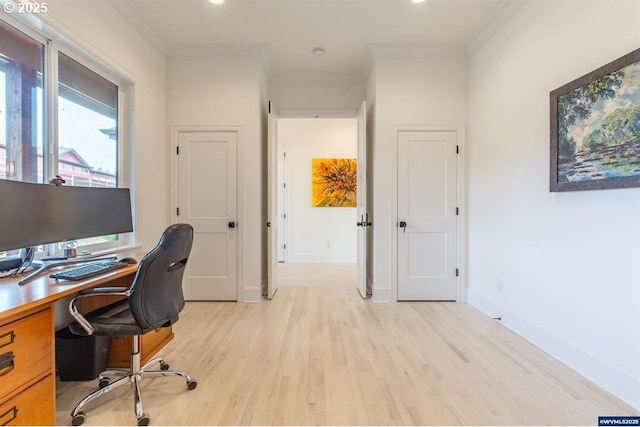 office area featuring light wood finished floors, baseboards, and ornamental molding