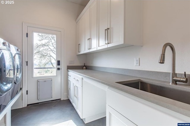 laundry room featuring tile patterned flooring, cabinet space, independent washer and dryer, and a sink