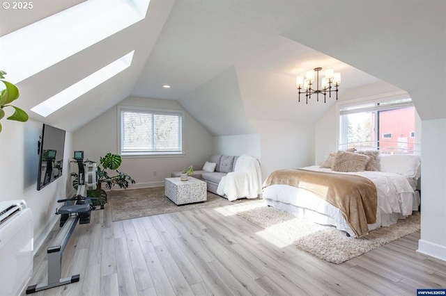 bedroom featuring baseboards, lofted ceiling with skylight, a notable chandelier, and wood finished floors