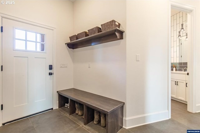 mudroom featuring tile patterned floors and baseboards