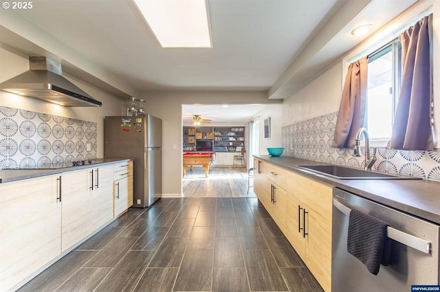 kitchen with wood tiled floor, light brown cabinetry, decorative backsplash, stainless steel appliances, and wall chimney exhaust hood